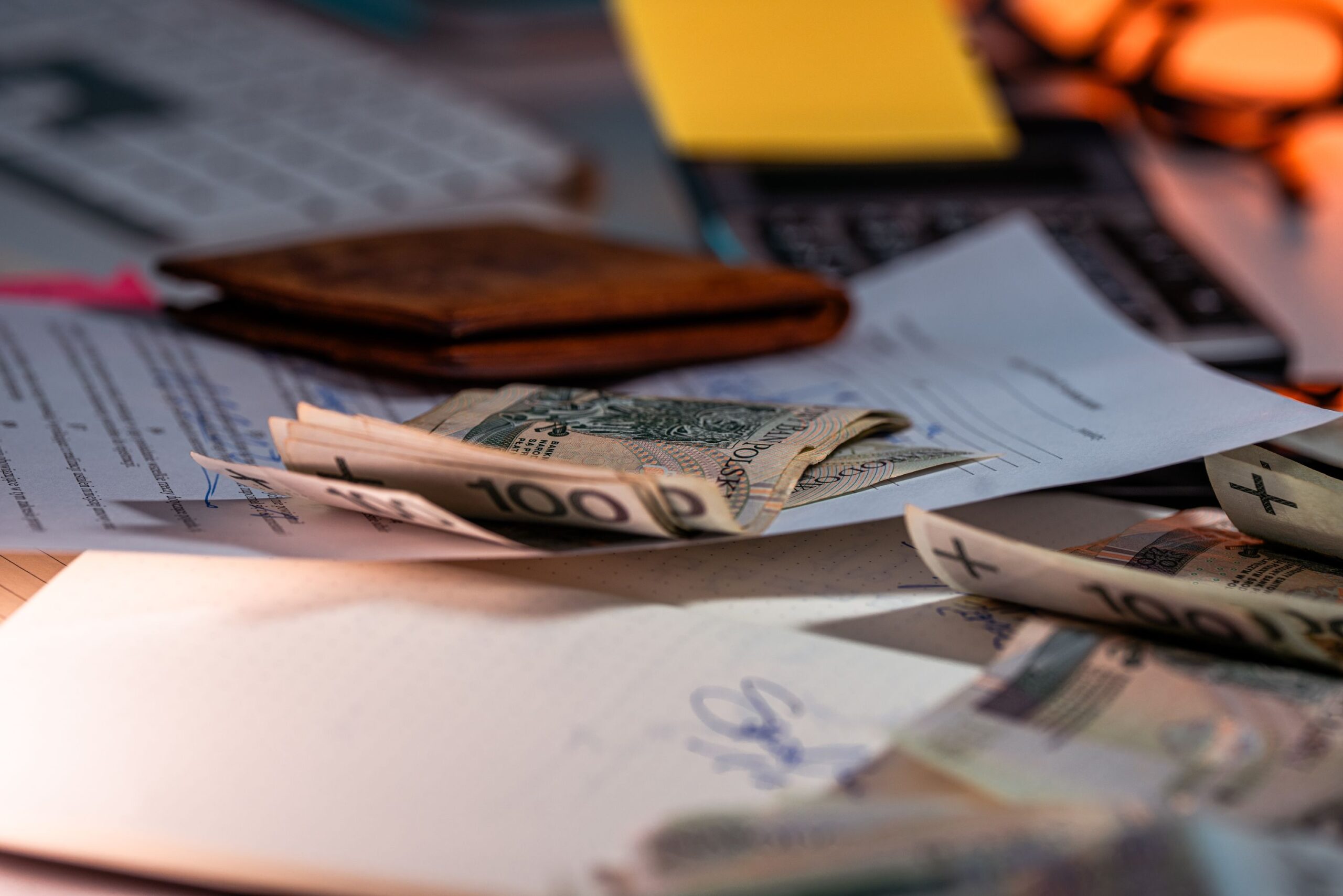 Paperwork and cash on a desk representing ACA open enrollment 2027 premium increases of about 14 percent