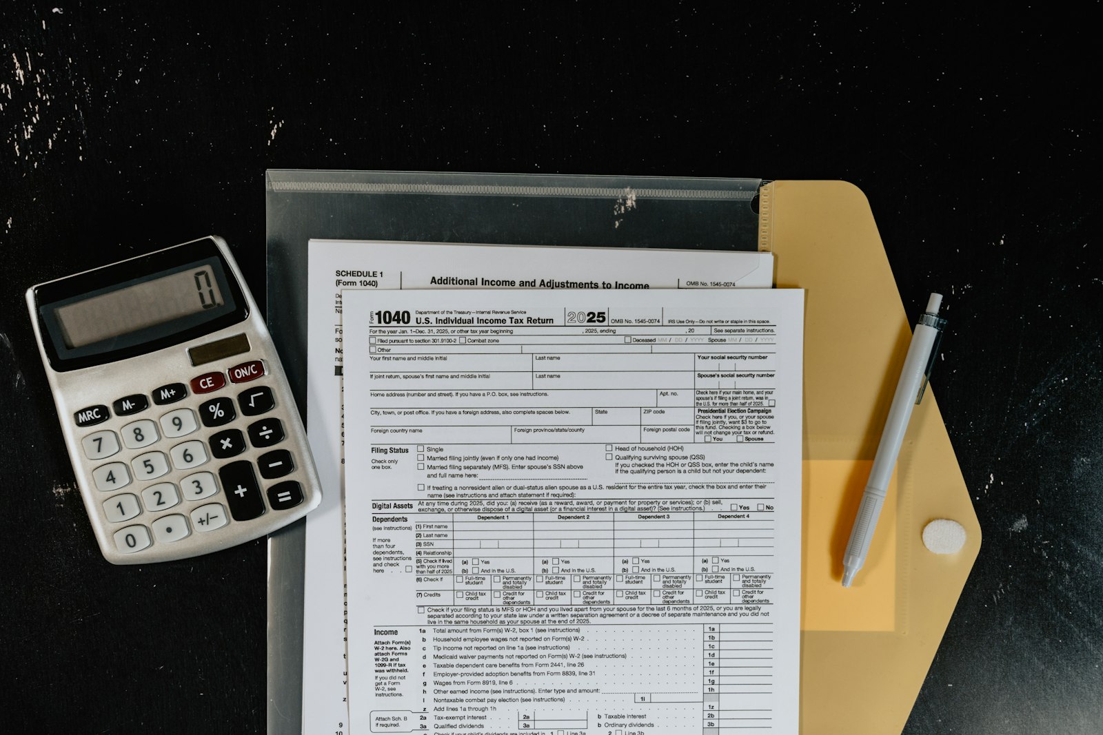 Calculator on top of paperwork, representing comparing the real cost of ChatGPT, Claude, and Gemini subscription tiers