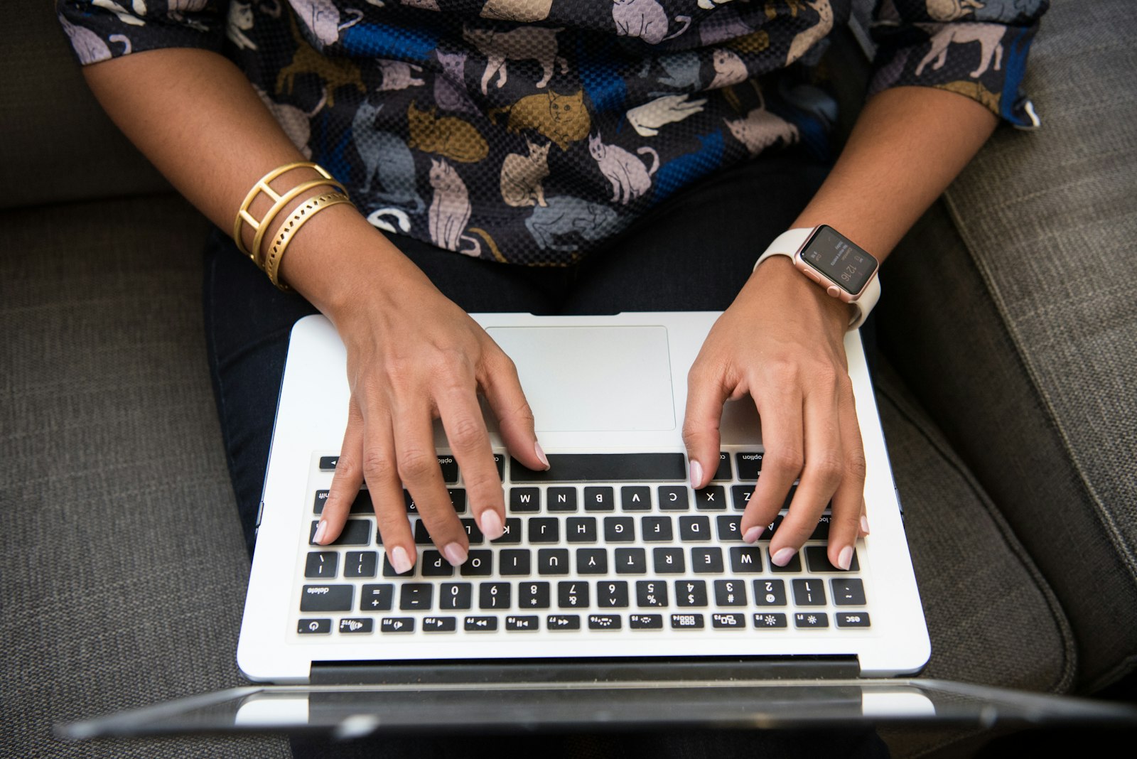 Person typing on a laptop, representing choosing between ChatGPT, Claude, and Gemini AI subscription pricing in 2026