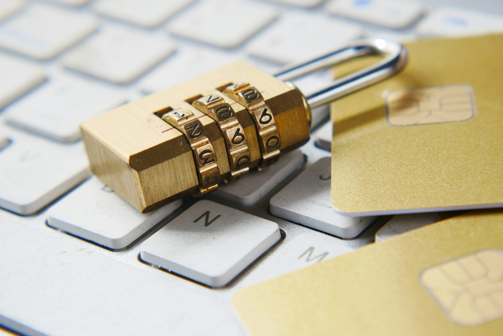 Golden padlock on a keyboard representing Apple spyware threat notifications and iPhone security in 2026
