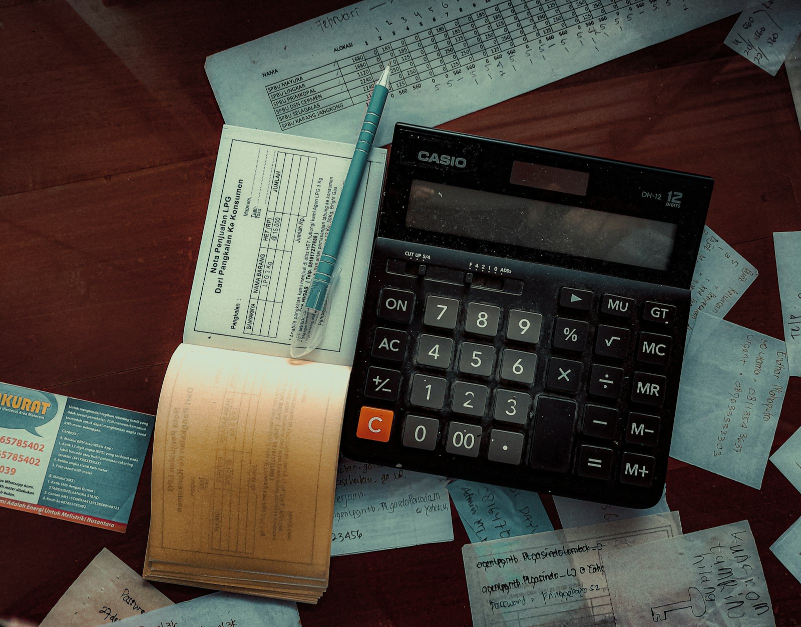 Calculator sitting on top of a wooden desk, representing the calculations handled by the best accounting software for small business in 2026