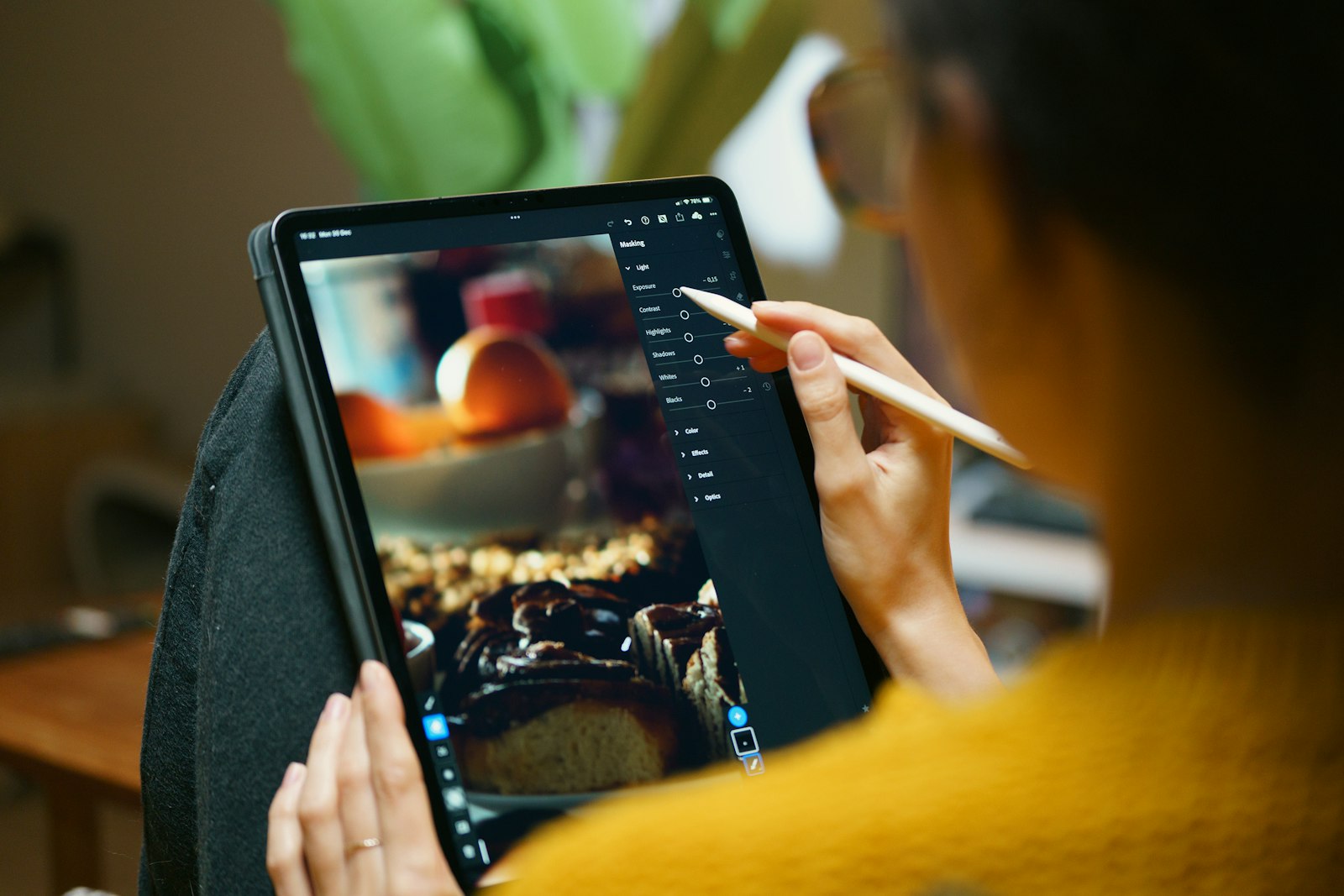 Person drawing on a digital tablet with a pencil, representing the creative workflow behind the best AI image generators in 2026