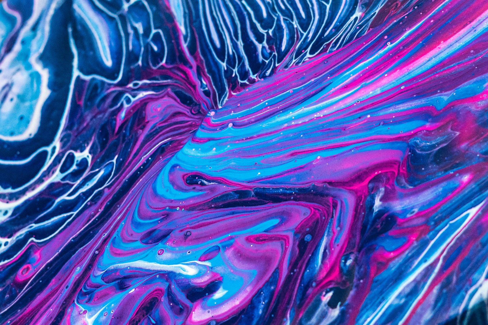 Purple and multicolored fluid art pattern, representing the vivid outputs possible with the best AI image generators in 2026