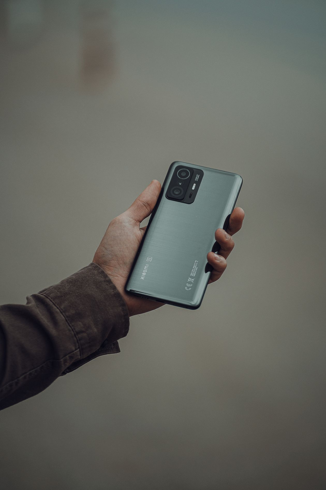 Close-up of a hand holding a modern smartphone, representing budget smartphones under ₹20,000