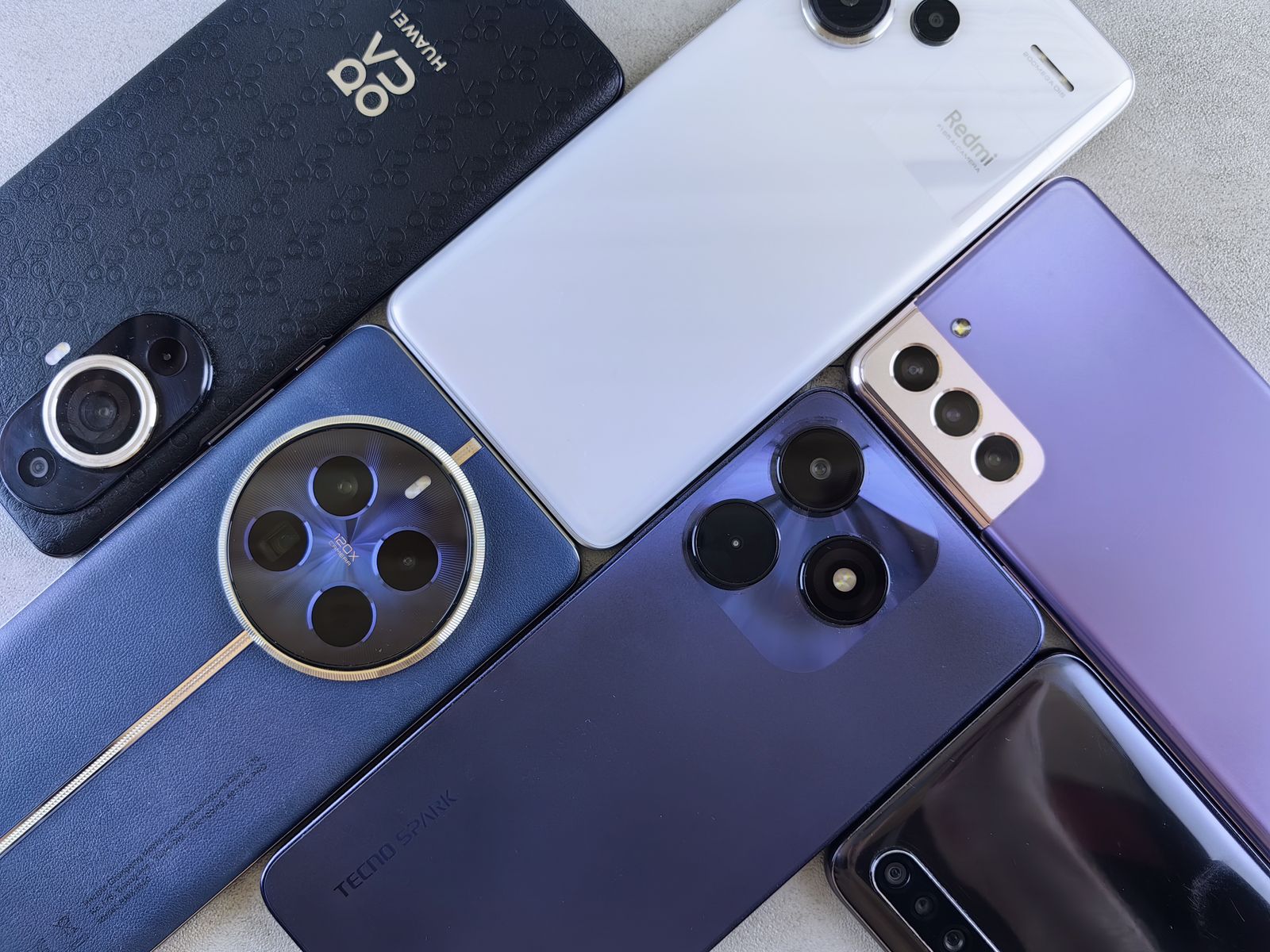 Top view of flagship smartphones showcasing different camera module designs in 2026