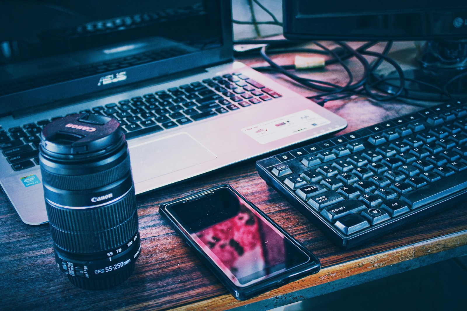 Smartphone beside a laptop on a desk, representing cross-device sync offered by the best cloud storage services in 2026