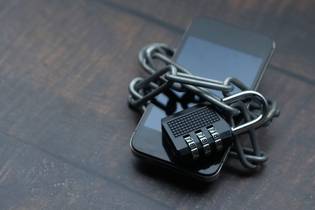 Smartphone secured with a padlock and chain representing a password manager app protecting personal data