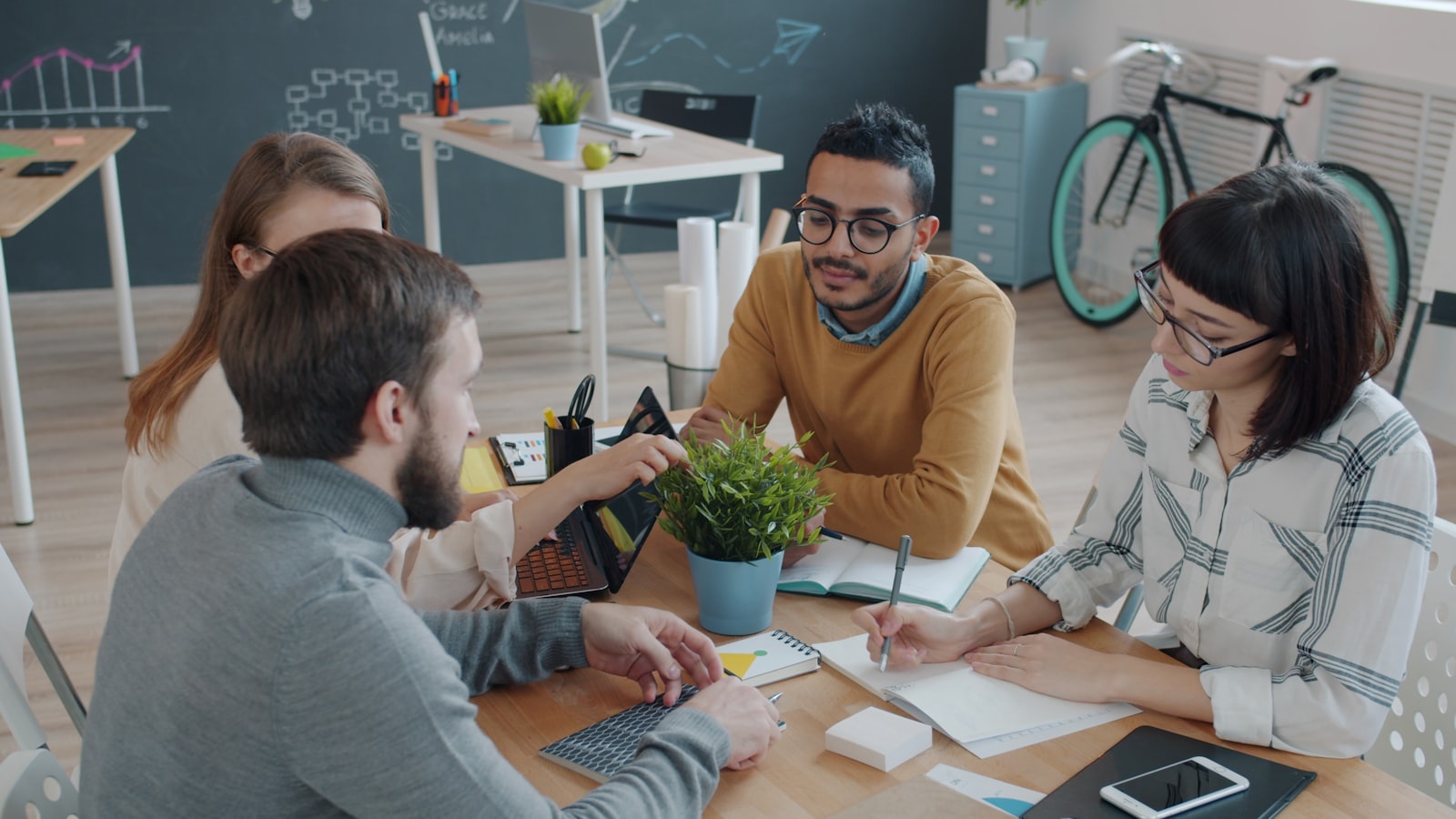 Diverse small business team collaborating in an office, representing choosing the best payroll software for a growing team in 2026