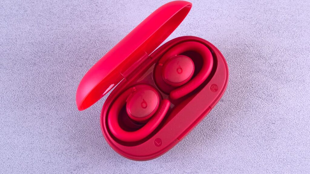 Red wireless earbuds with charging case, representing the best budget TWS earbuds under ₹2000