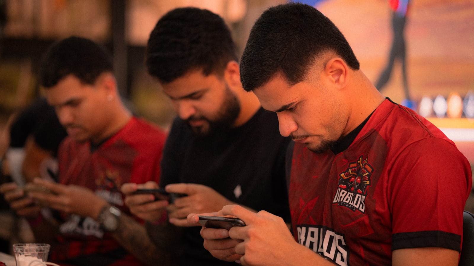 Group of gamers looking at their smartphones representing the BGMI India Series 2026 esports tournament