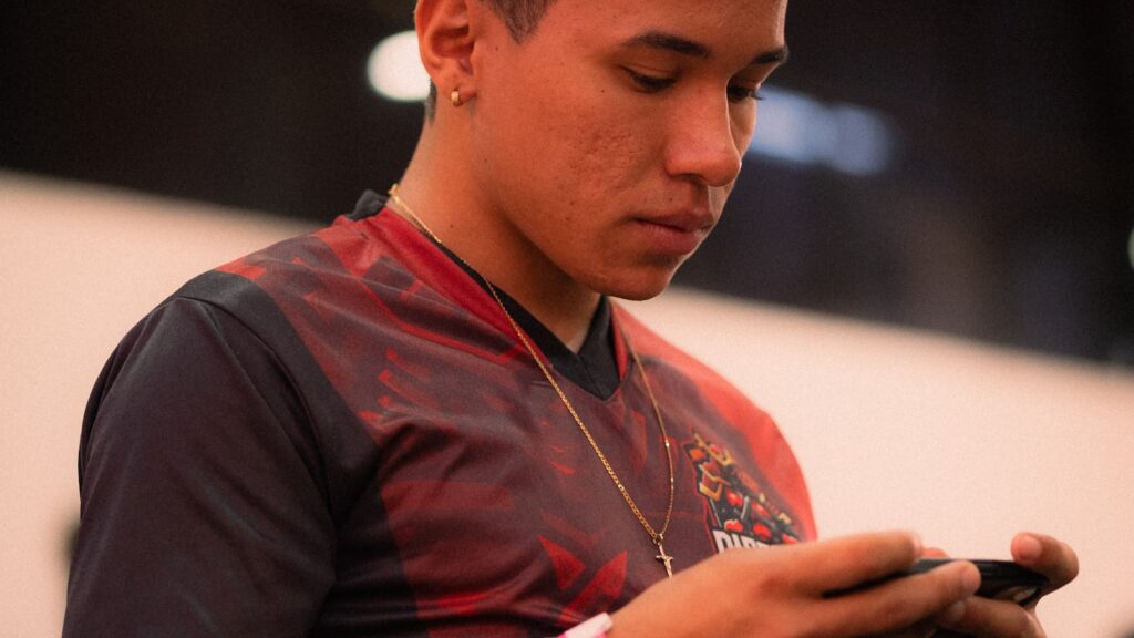 Young man focused on playing a mobile battle royale game representing BGMI Lite for budget Android phones