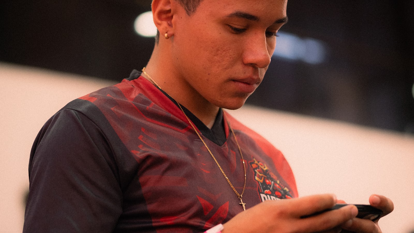 Young man focused on playing a mobile battle royale game representing BGMI Lite for budget Android phones