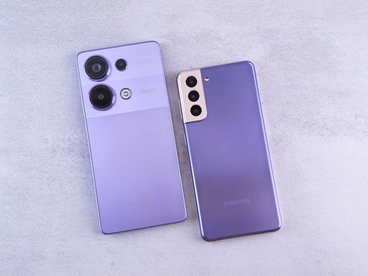 Person comparing two smartphones side by side to decide which budget phone to buy