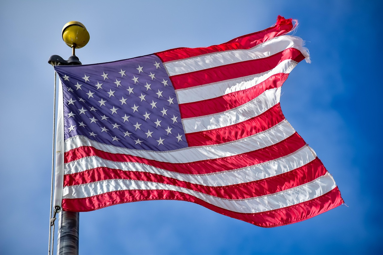 American flag on a flagpole, symbolizing the national tributes and flag-lowering order for Dolly Parton