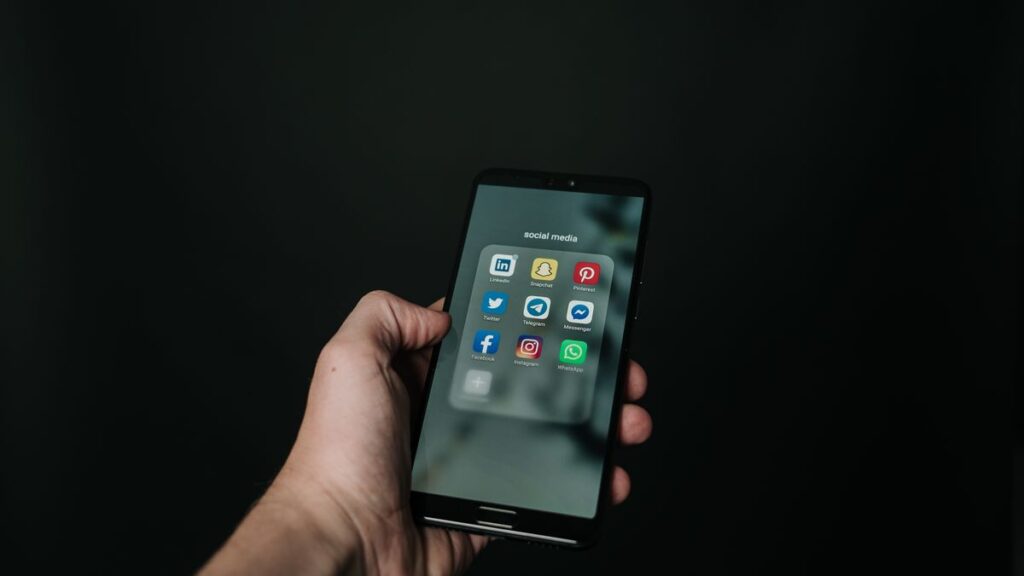 Hand holding a black smartphone, representing the Google Pixel 11 series launch in India