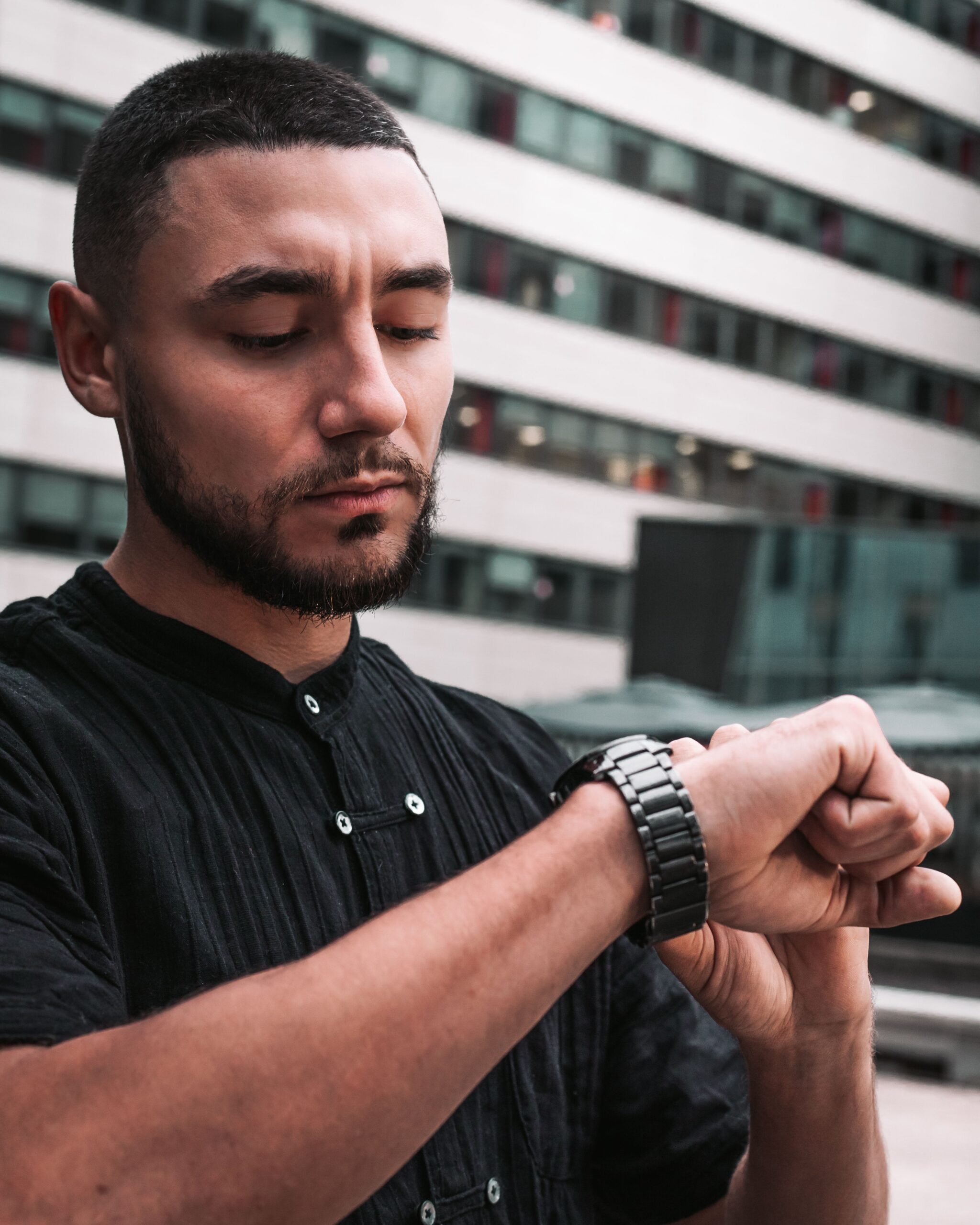 Man checking a smartwatch outdoors, representing the Google Pixel Watch 5 improved GPS and location tracking accuracy