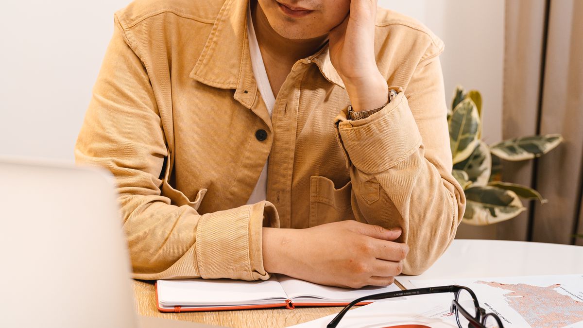 Frustrated man sitting at a laptop, representing a slow Windows PC in need of a speed-up fix