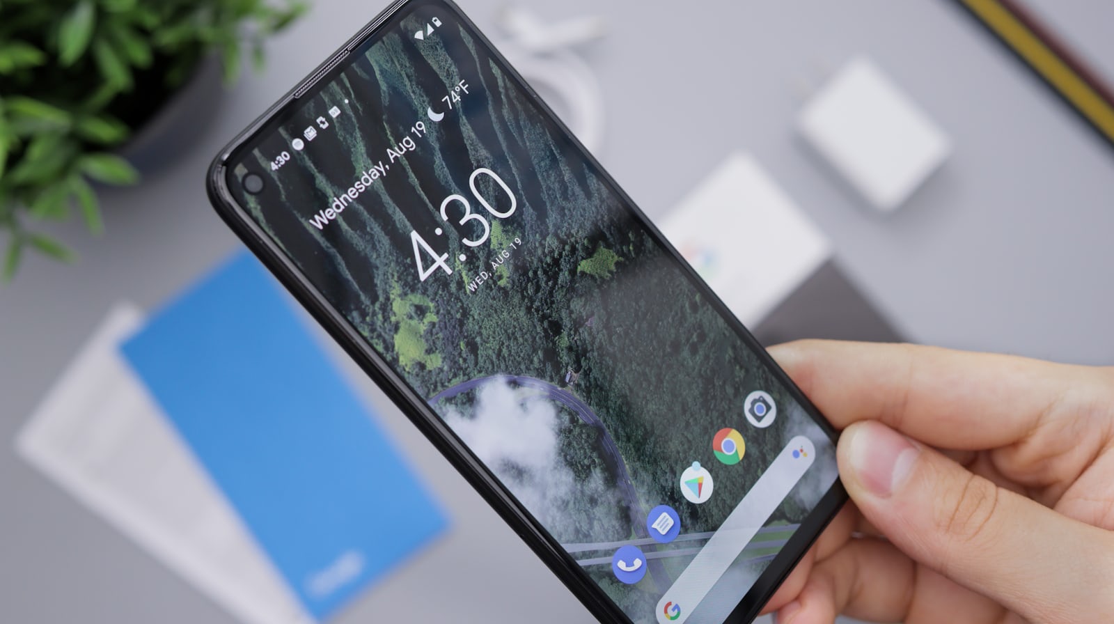 Person holding a black Android smartphone representing the POCO M8x 5G launch in India