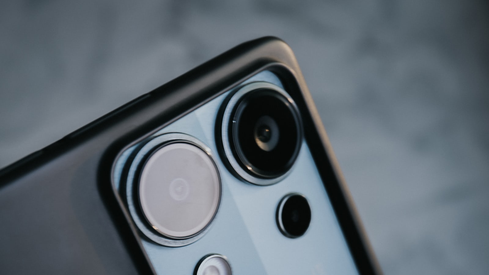 Close-up of a smartphone camera module with multiple lenses representing the Galaxy S26 FE's expected triple camera setup
