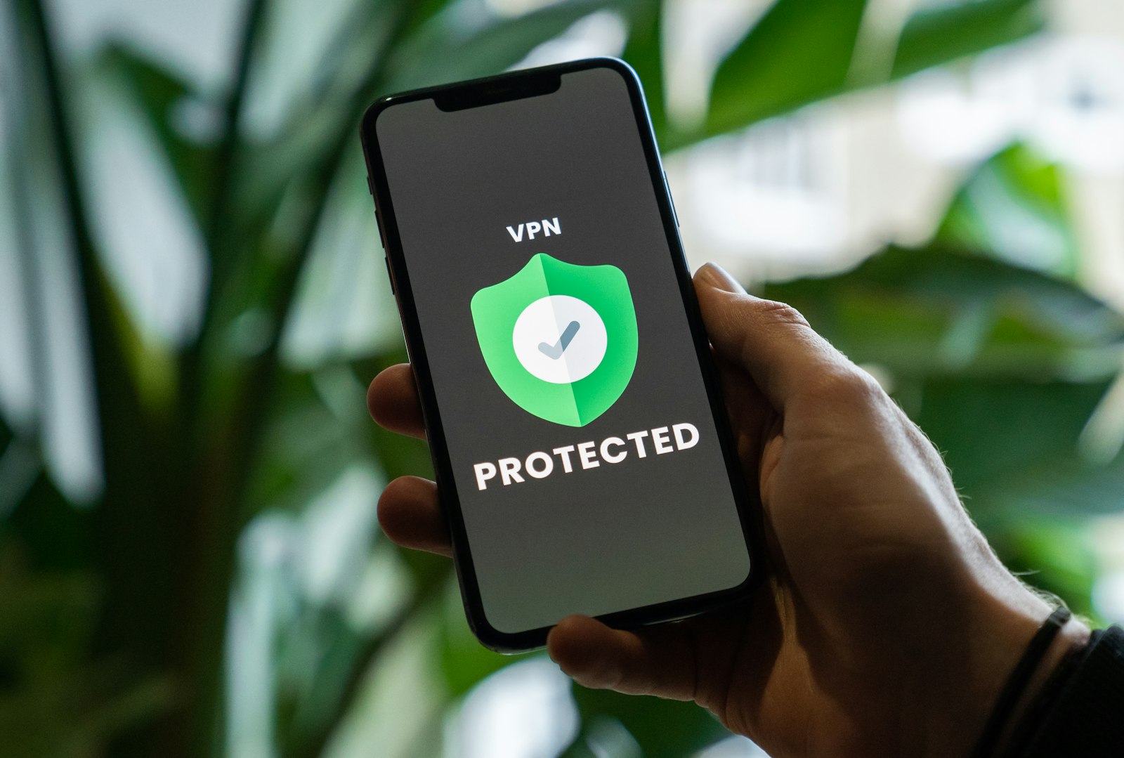 Person holding a smartphone with a VPN privacy service enabled, representing exercising data privacy rights under state privacy laws in 2026