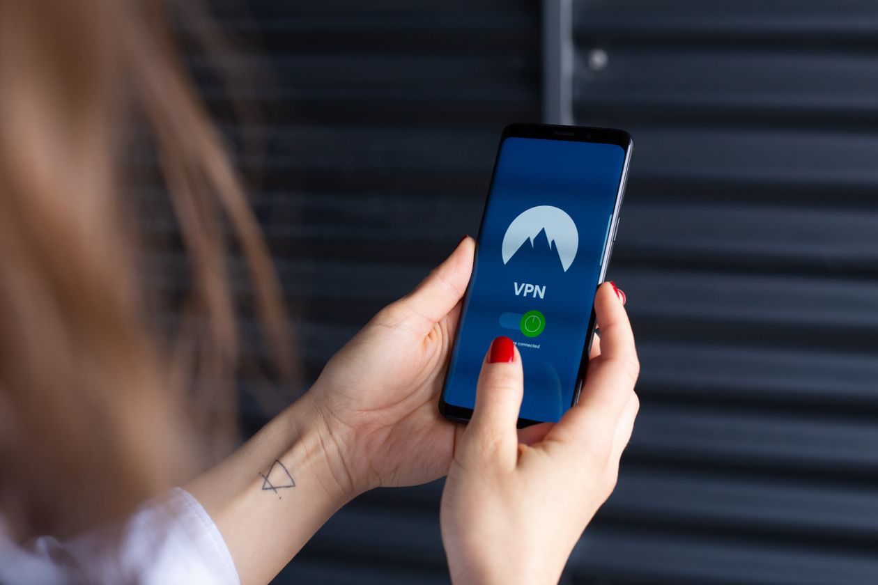Person using a secure app on a smartphone to manage saved passwords and logins