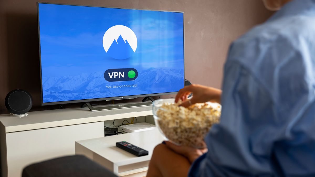 Relaxed scene at home with a person watching TV, representing secure VPN streaming access