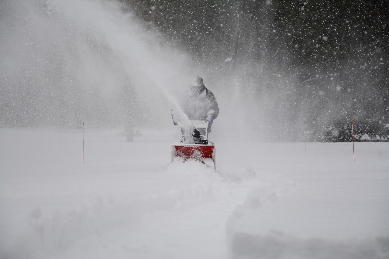 Homeowner clearing snow ahead of the winter forecast 2026-2027 storm season