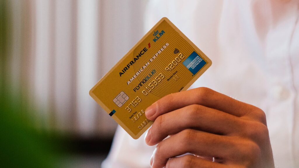 Person holding a credit card representing X Money's Visa debit card and digital payments launch in the US