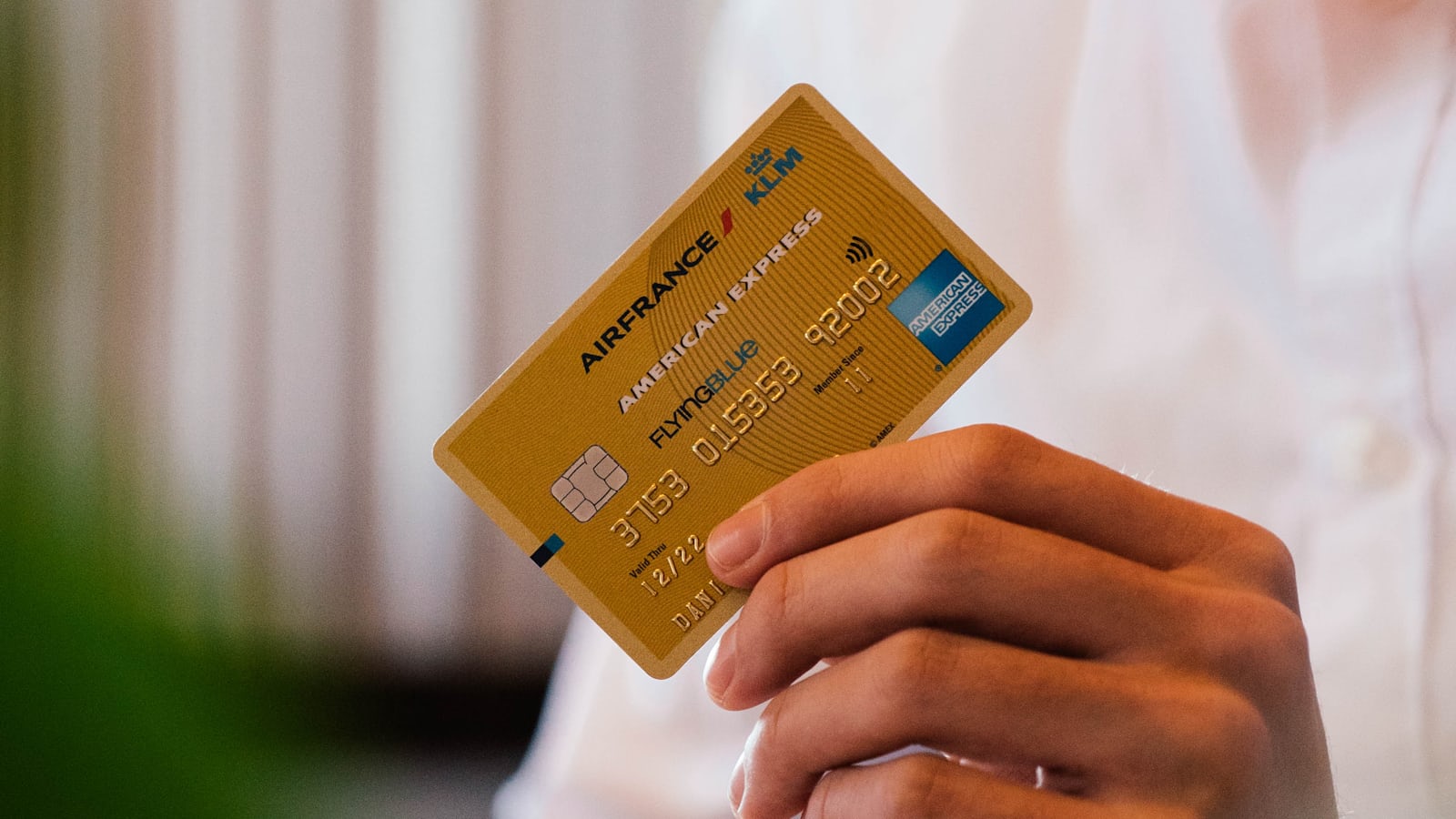Person holding a credit card representing X Money's Visa debit card and digital payments launch in the US