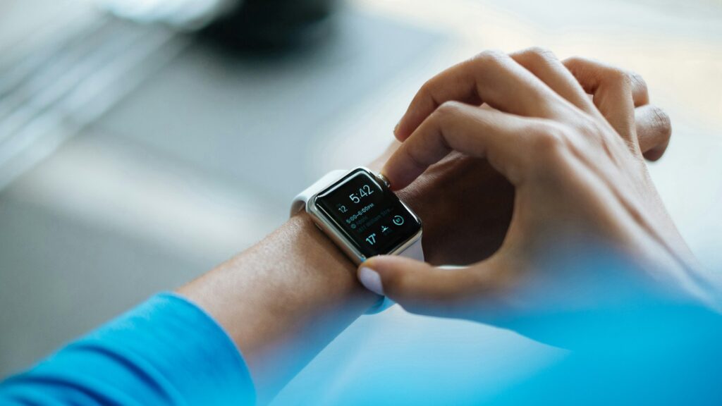 Person using a smartwatch on their wrist, illustrating the Apple Watch Ultra 4 review of health and fitness features