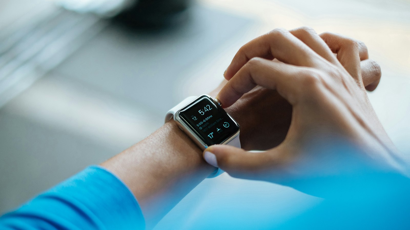 Person using a smartwatch on their wrist, illustrating the Apple Watch Ultra 4 review of health and fitness features