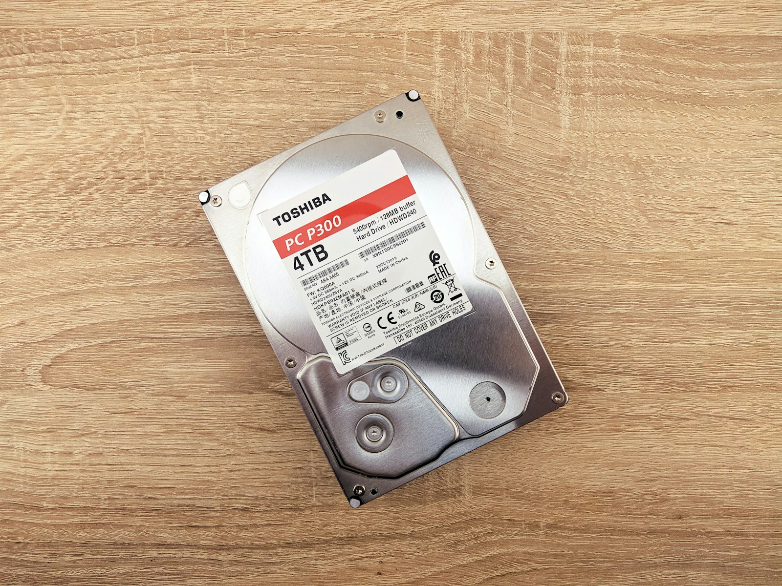 External hard drive on a wooden table, representing local backup that the best cloud backup services 2026 like Backblaze and IDrive protect against loss