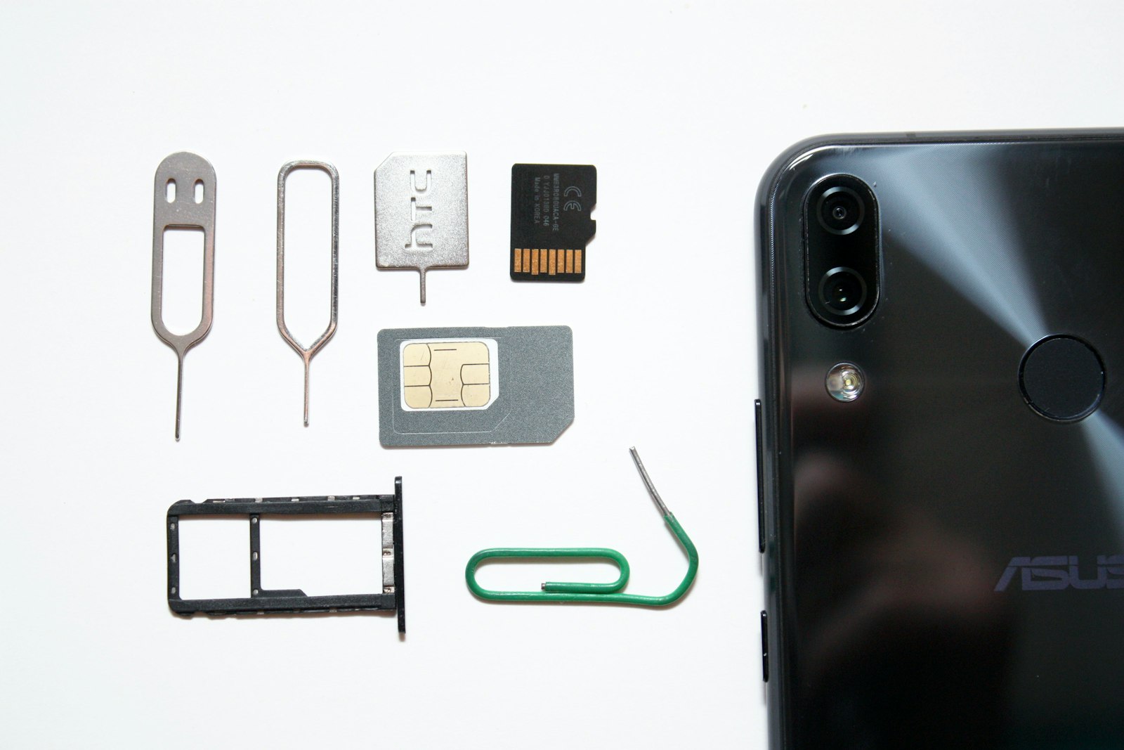 Smartphone with a SIM card being inserted, illustrating how to switch to a prepaid carrier for the best prepaid phone plans 2026
