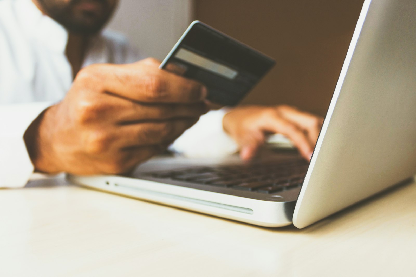 Person shopping online with a credit card, representing how buy now pay later loans from Klarna, Affirm, and Afterpay affect your credit score in 2026