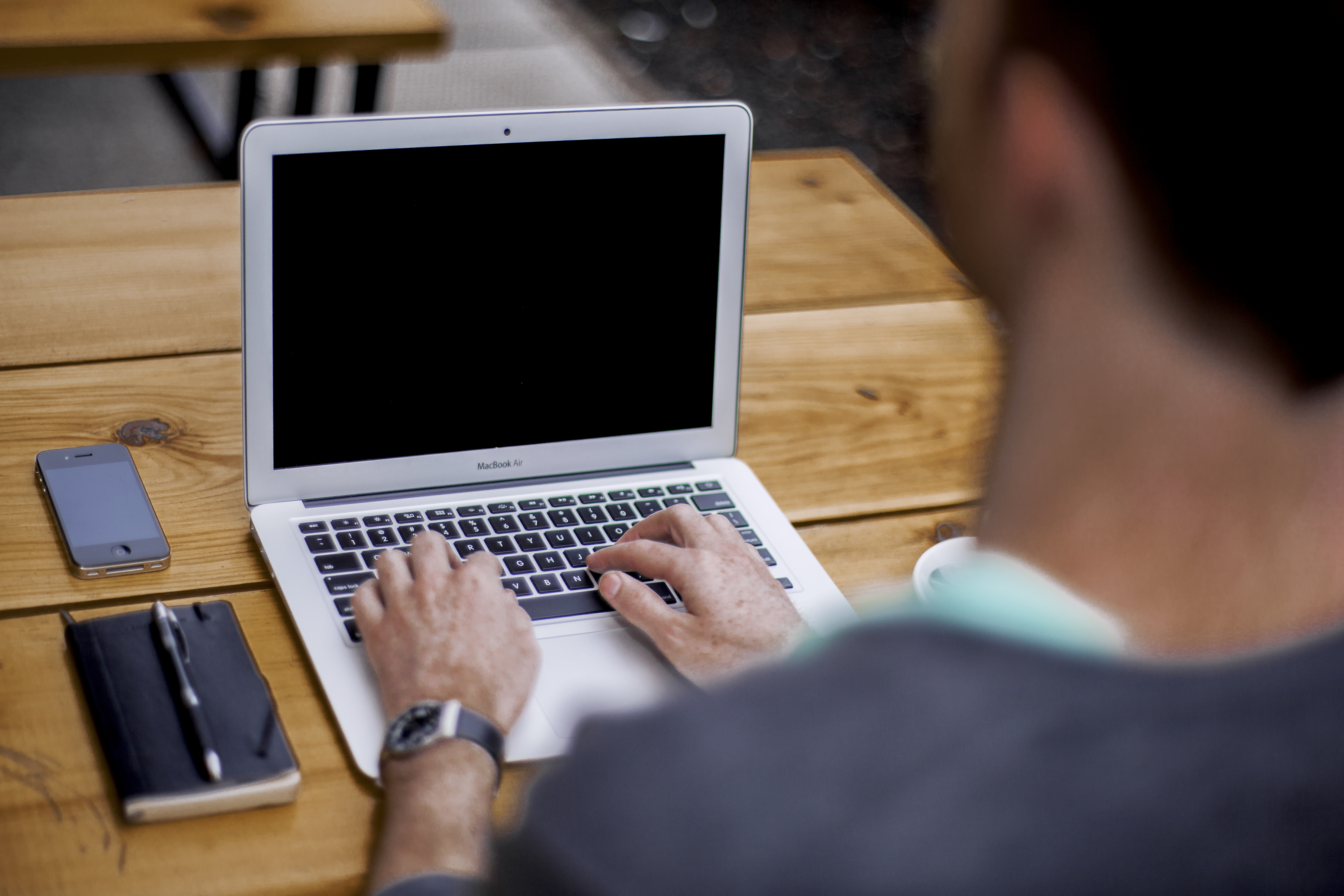 Person typing on a laptop setting up business automation tools to make money online