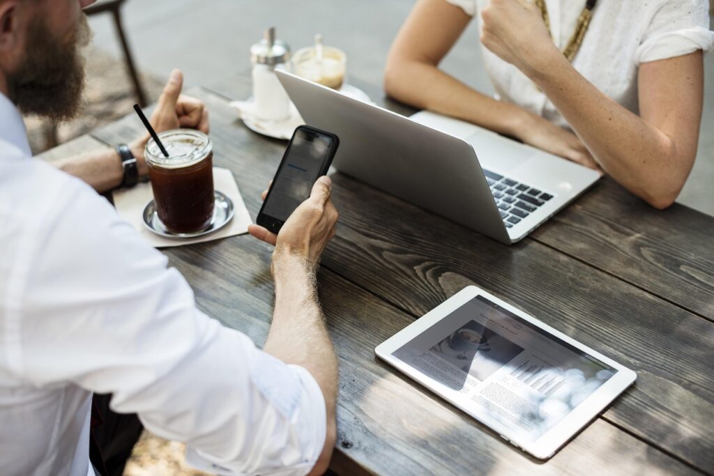 Two people reviewing a laptop and business plan, representing business automation for making money online