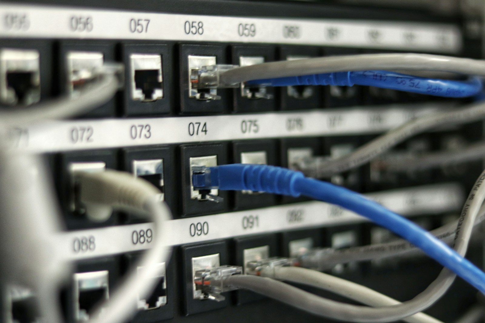 Blue network cables connected to servers, illustrating the internet infrastructure that Cloudflare's DNS, CDN, and edge computing services route traffic through
