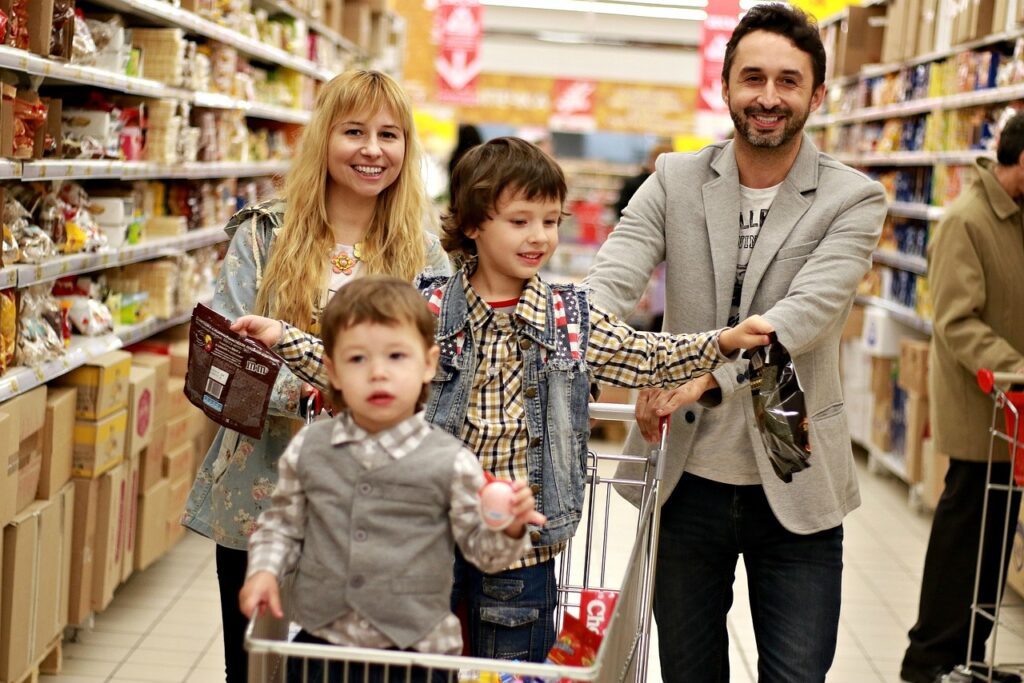 Family shopping at a warehouse-style retail store, representing the Costco Next membership perk shutdown