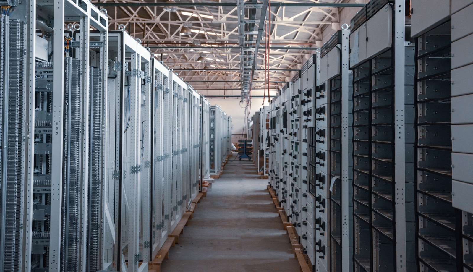 Server room aisle with metal equipment racks, representing the backend infrastructure behind Discord's repeated 2026 API and voice outages