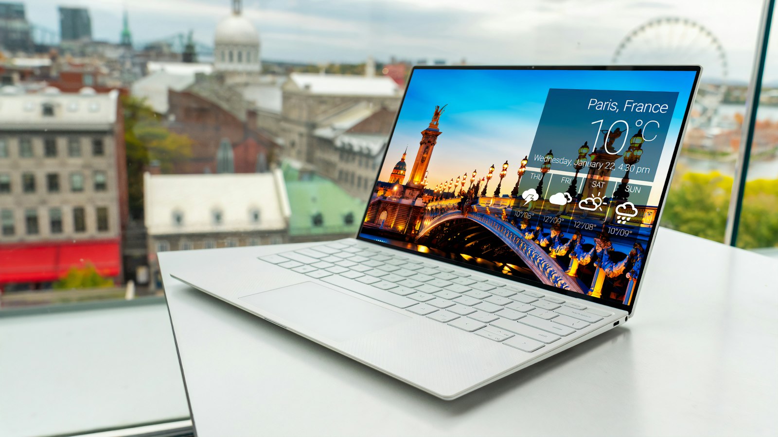 Thin premium laptop on a white table, representing the new Googlebook laptops from Dell, HP, Acer, ASUS and Lenovo
