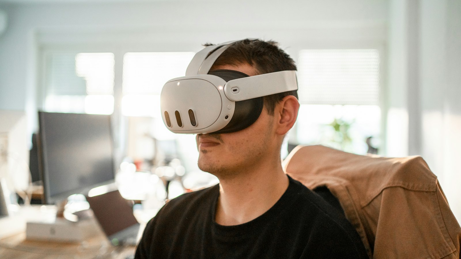 Man relaxing in a chair wearing lightweight virtual reality glasses, illustrating Meta Connect 2026 wearable announcements