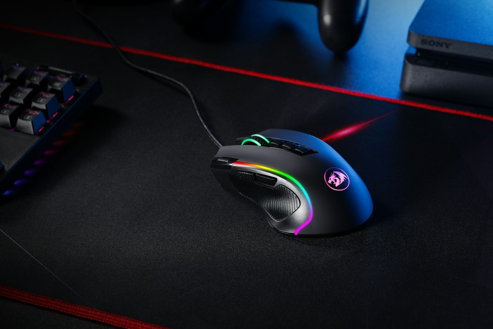Black computer keyboard beside a gaming monitor, representing the PC gaming infrastructure at the center of the Nexus Mods acquisition of SteamDB in 2026