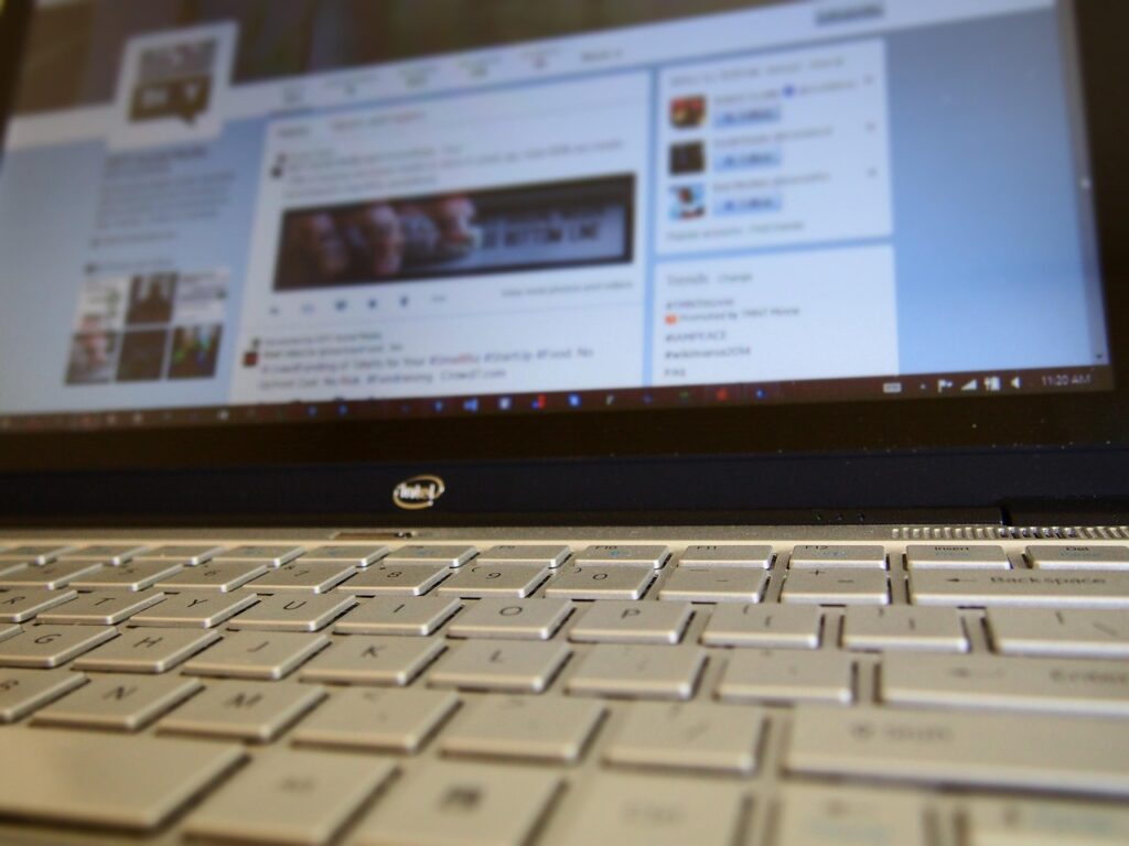 Laptop showing social media apps, representing social media marketing productivity tools