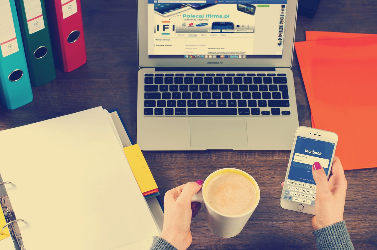 Workspace with laptop and phone, showing a social media marketing productivity workflow setup