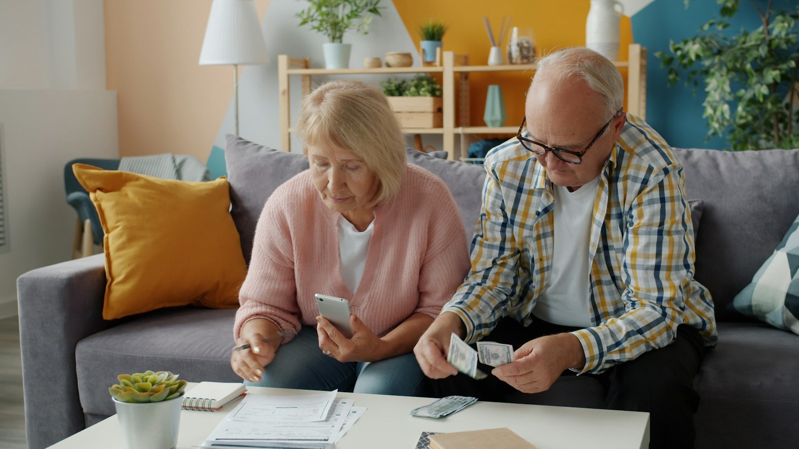 Elderly couple managing finances at home, representing retirees planning for the Social Security COLA 2027 increase