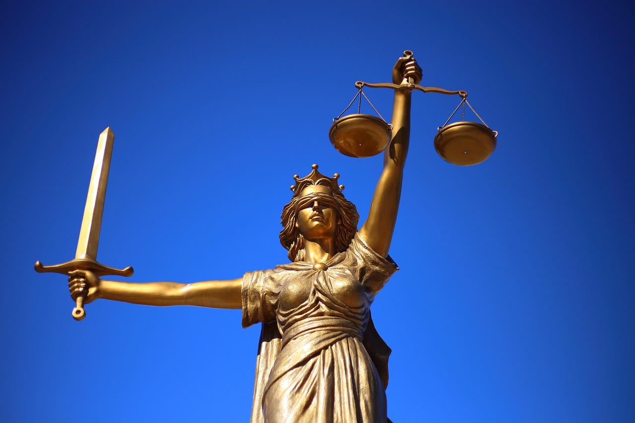 What Does a Mistrial Mean Lady Justice Scales Statue of Lady Justice holding scales, symbolizing the legal process behind a mistrial and retrial