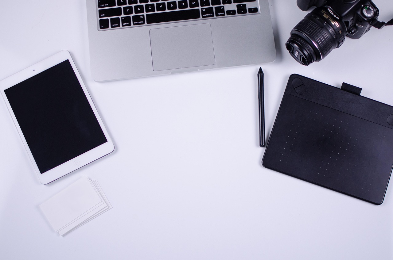 Flat lay of a blogger's laptop and desk setup, representing a workflow automation for blogging and SEO